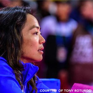 Close up of Clarissa Chun watching fellow wrestlers compete